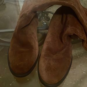 Suede boots over the name Coco Brown. Riding boots